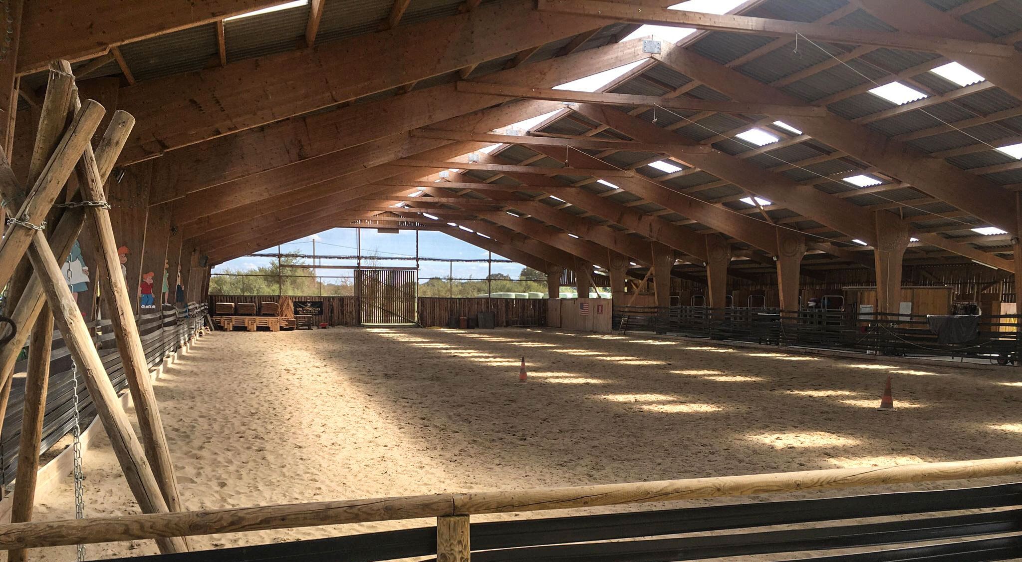 Indoor arena: sand surface and timber frame