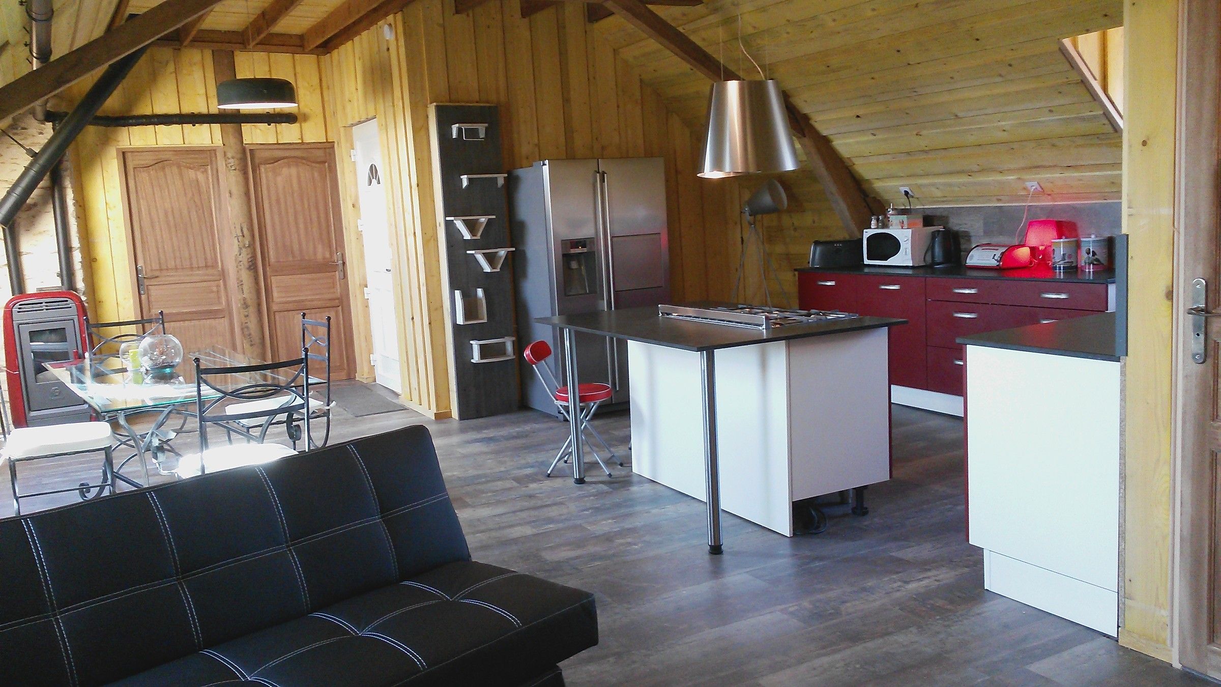 The open-plan kitchen and living room of the Loft, with wooden walls