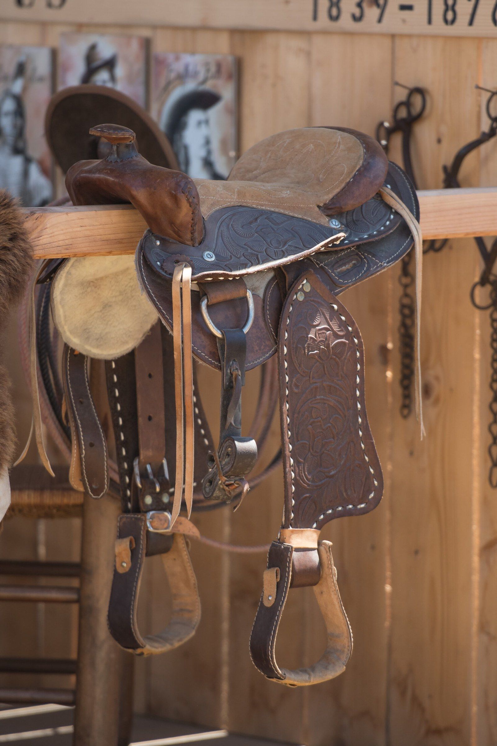 Western saddle on its saddle rack, in a tack room
