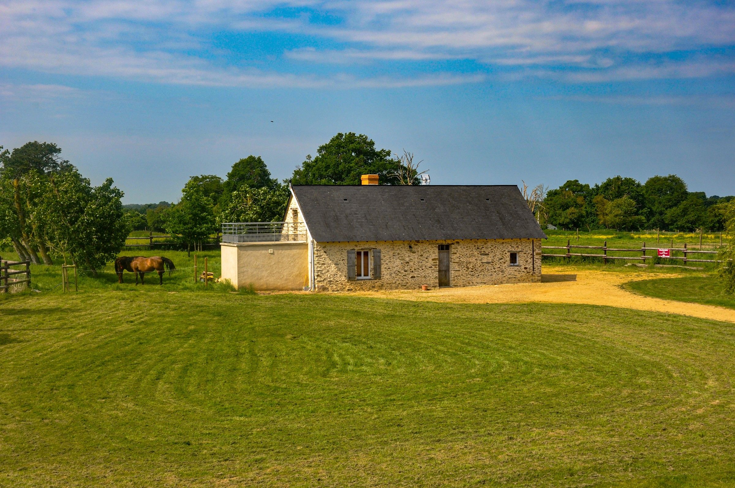 The Thom’House, a small stone house in the middle of a large lawn